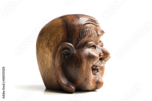 Wooden happy Buddha head statue. Souvenir from Indonesia  Southeast Asia. White background.