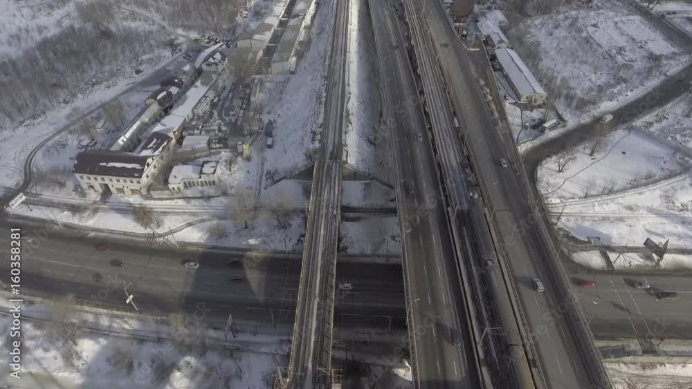 aerial view on the road and railways. Urban landscape in winter season. Train and cars are going by the town. aerial view on the road and railways. Urban landscape in winter season. Train and cars are going by the town.