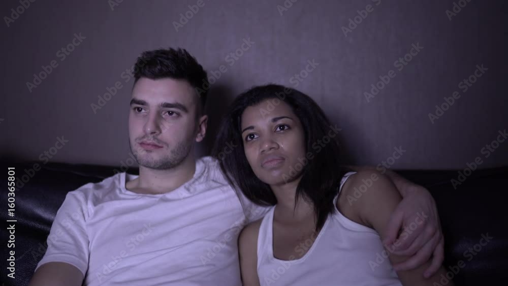 Loving couple man and woman watching TV set romantic film about love, woman is crying man falls asleep. 4K Loving couple man and woman watching TV set romantic film about love, woman is crying man falls asleep. 4K