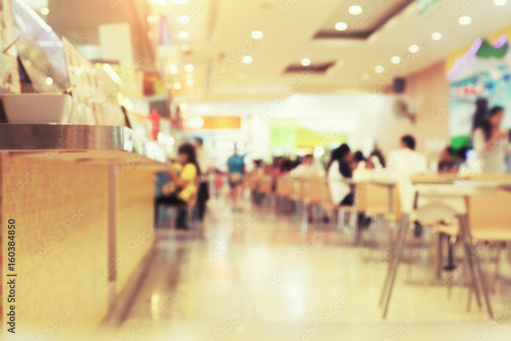 Food court or foodcourt interior blurred background. May called restaurant or canteen include coffee shop with table, people at indoor plaza, mall, store or shopping center in Chiang mai of Thailand.