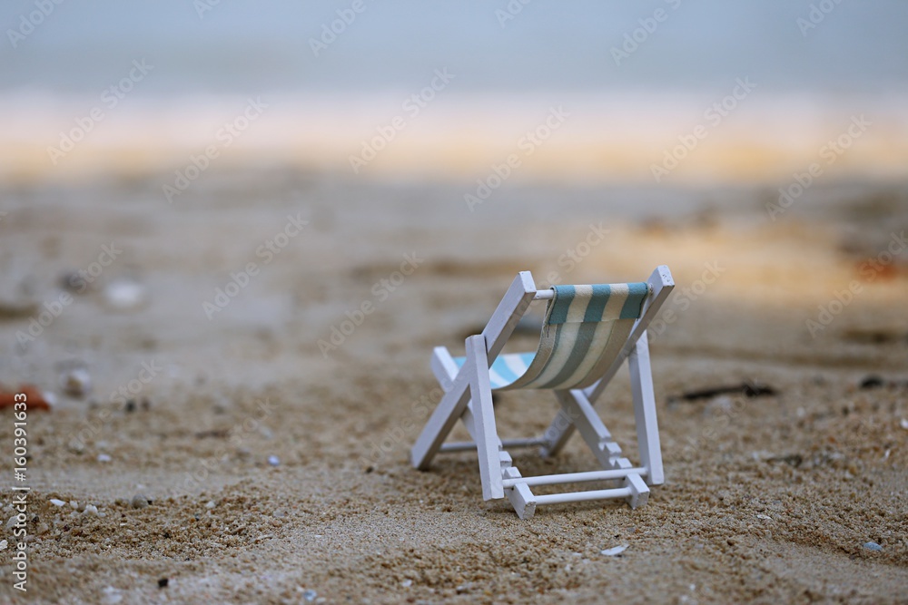 Beach chair on sandy beach tropical summer holidays with blur ocean background Beach chair on sandy beach tropical summer holidays with blur ocean background