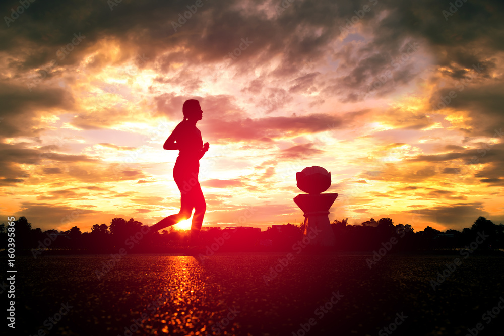 A woman jogging in park at sunset,silhouette image for abstract background.