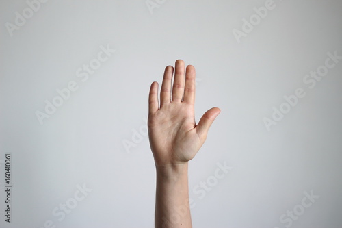 Young woman's hand isolated on light gray background. Gesture