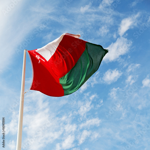 in oman waving flag and the cloudy sky