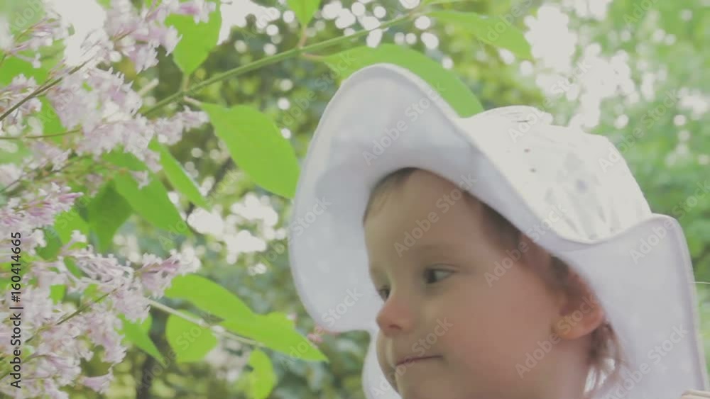 Family walks in the park with children. Sunny day. Green trees Family walks in the park with children. Sunny day. Green trees