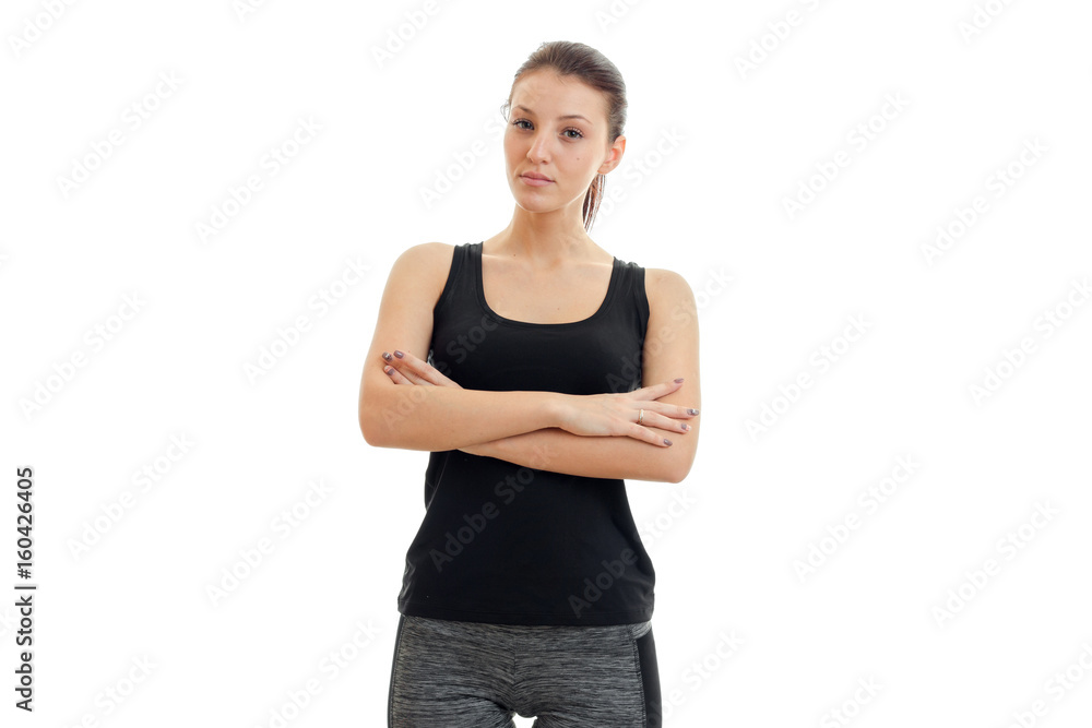 beautiful young girl in a black t-shirt folded her hands and looking at camera beautiful young girl in a black t-shirt folded her hands and looking at camera