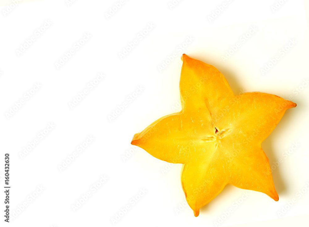 Fototapeta premium Close-up of orange yellow color sliced ripe Star Fruit on white background, with free space for design and text 