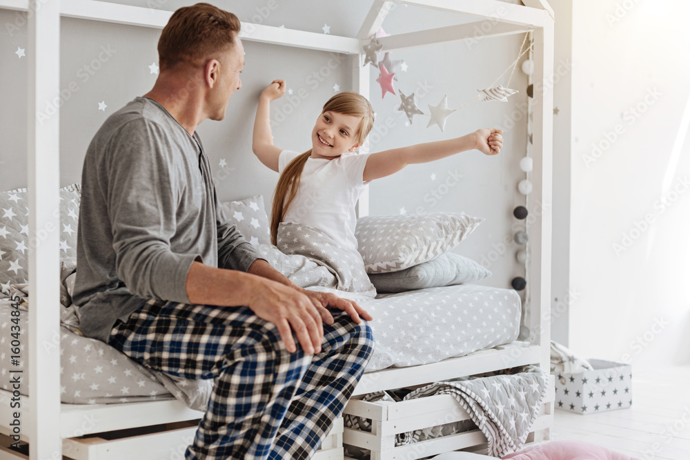 Fototapeta premium Admirable active child stretching in her bed