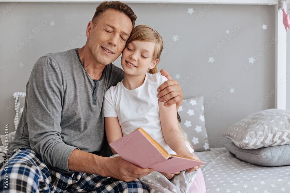 Affectionate charming father hugging his little girl Affectionate charming father hugging his little girl