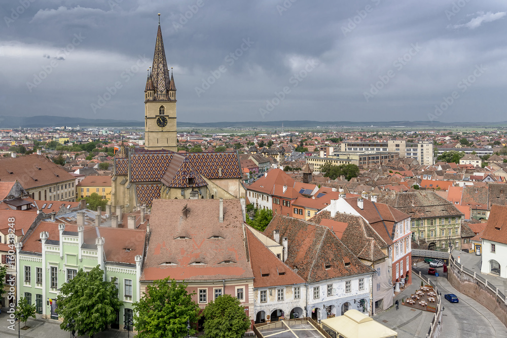 Breathtaking aerial view on the famous Piata Mica, Small Square, from the top of the Council Tower, in the historic center of Sibiu, Romania, with the Saint Mary Cathedral in the background