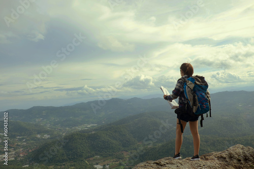 woman stand on the mountain with travel and adventure concept vintage tone.
