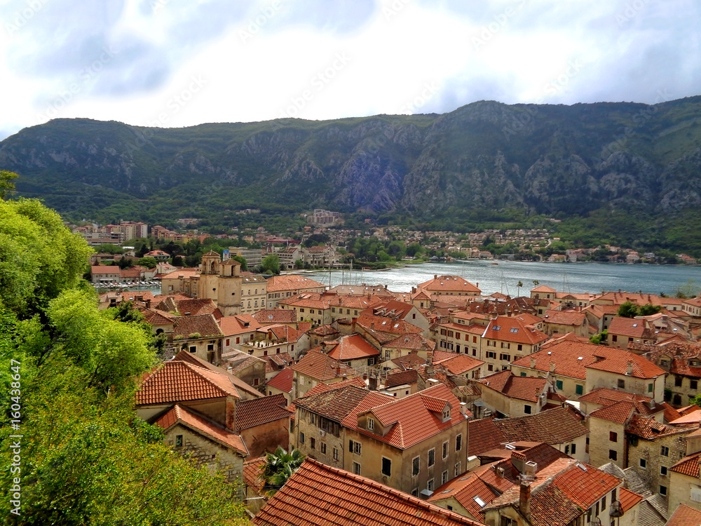 Aerial view of vibrant colored tiled roofs of Kotor Old City on the shore of Kotor Bay, Kotor, Montenegro 