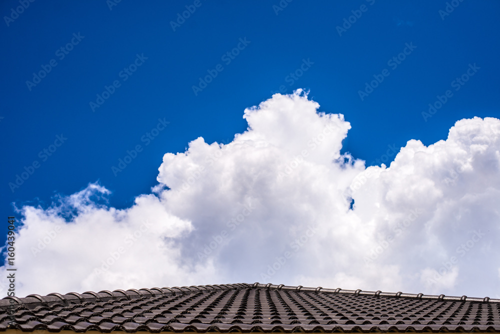 Roof below a bright blue sky with cloud Roof below a bright blue sky with cloud