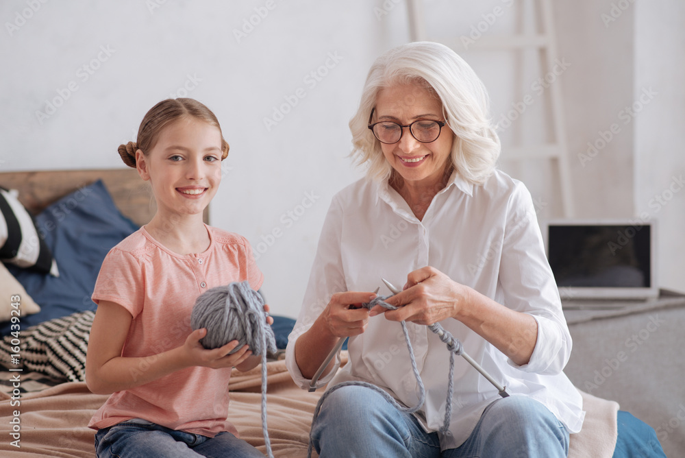 Fototapeta premium Pretty young girl helping her grandmother