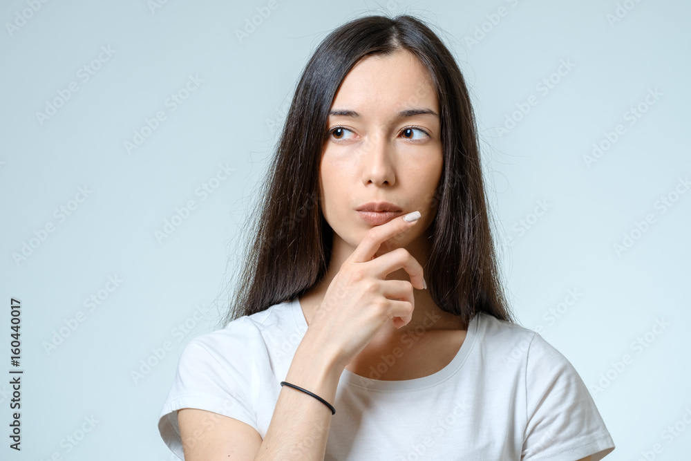 Portrait of beautiful young confident woman with serious expression Portrait of beautiful young confident woman with serious expression
