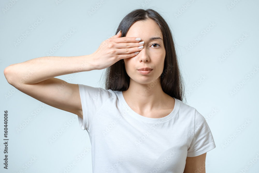 Young girl covering her eyes Young girl covering her eyes