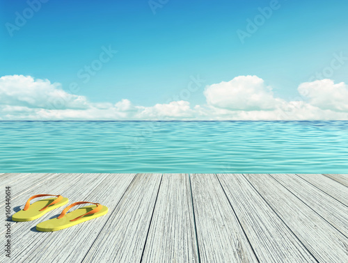 Fototapeta Naklejka Na Ścianę i Meble -  Yellow flip flops on a wooden floor by the seashore
