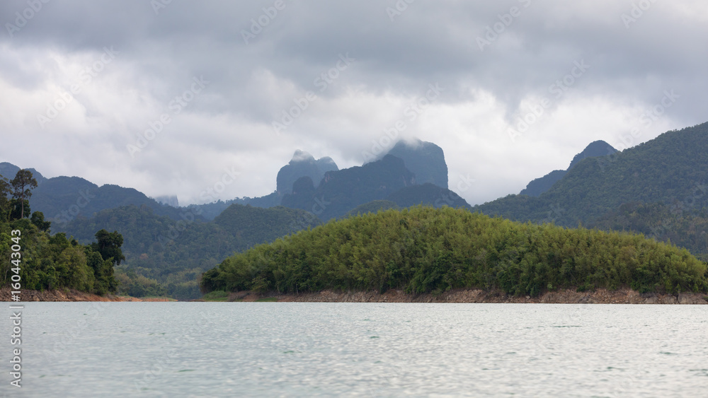 Islands and shores of Lake Ratchaprapha with a gray sky Islands and shores of Lake Ratchaprapha with a gray sky