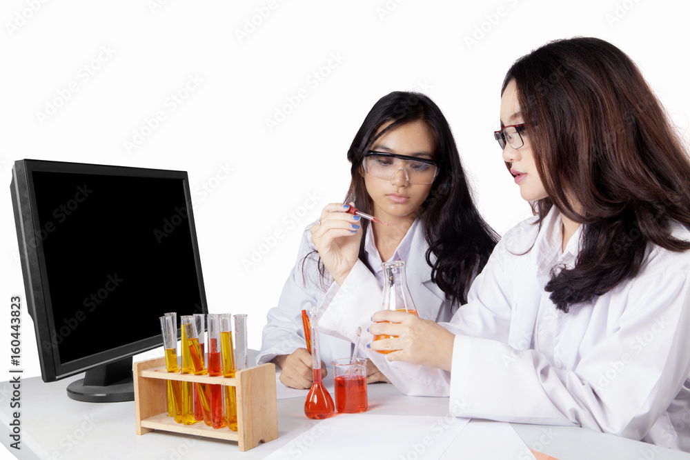 Two students doing chemical experiment Two students doing chemical experiment
