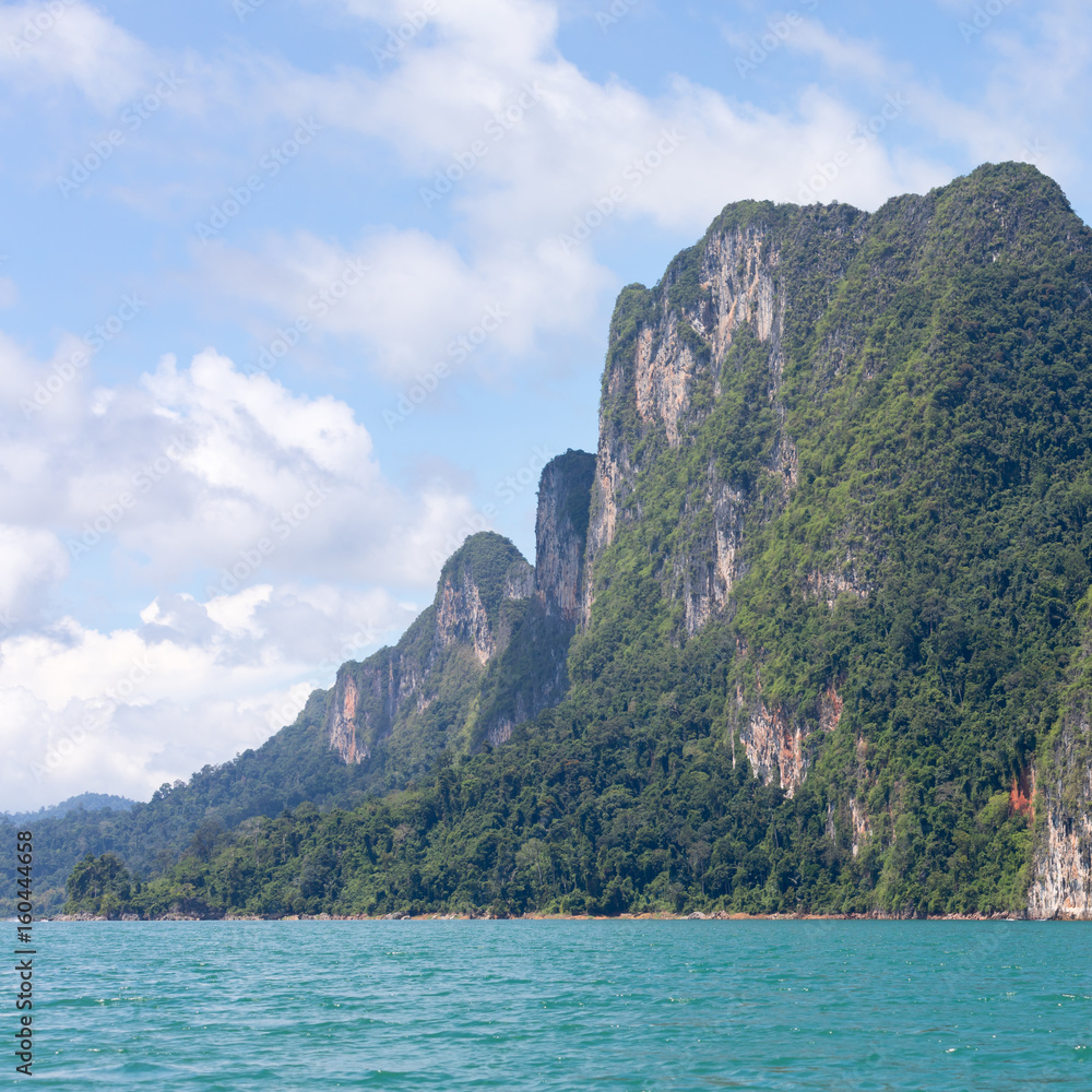 Mountain covered with vegetation on the lake Ratchaprapha in Thailand Mountain covered with vegetation on the lake Ratchaprapha in Thailand
