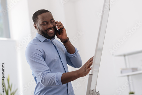 Pleasant handsome man holding a cell phone