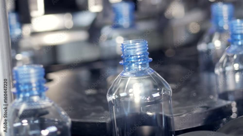 Plastic bottles filled with water moving on a conveyor. Plastic bottles filled with water moving on a conveyor.
