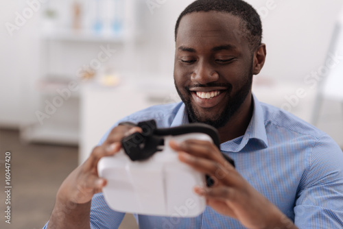 Pleasant cheerful man holding 3d glasses