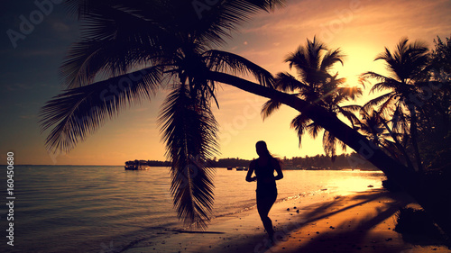 Sea sunrise. Girl running on the tropical island beach Punta Cana © ValentinValkov