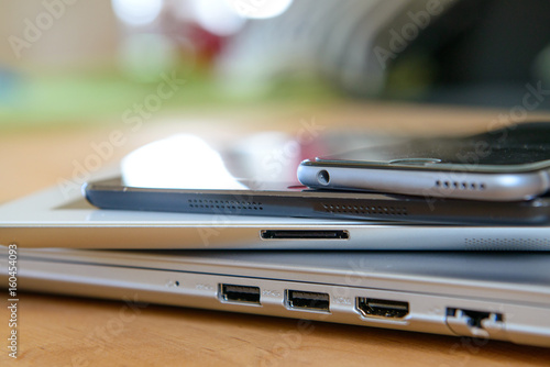 pile of different computers and phone