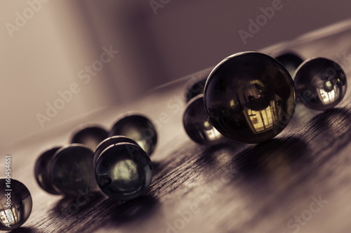 Glass balls on a wooden surface at an angle. Stylish artistic work. Selective focus.