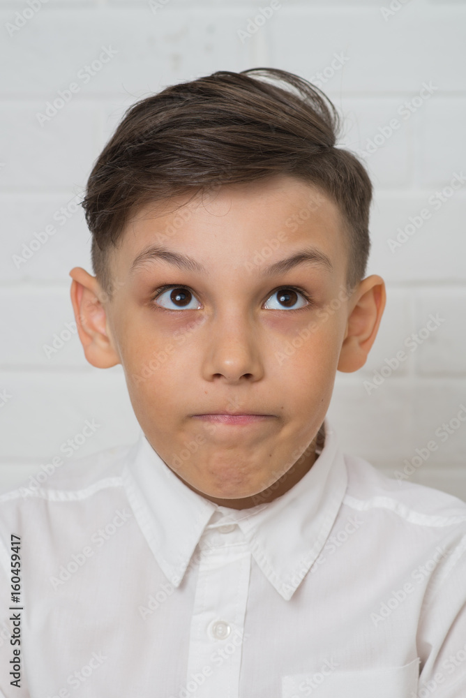 Thoughtful boy in white shirt, closeup portrait Thoughtful boy in white shirt, closeup portrait