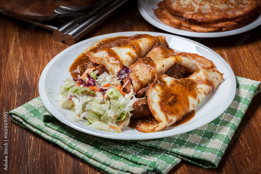 Potato pancakes with meat stew served Potato pancakes with meat stew served