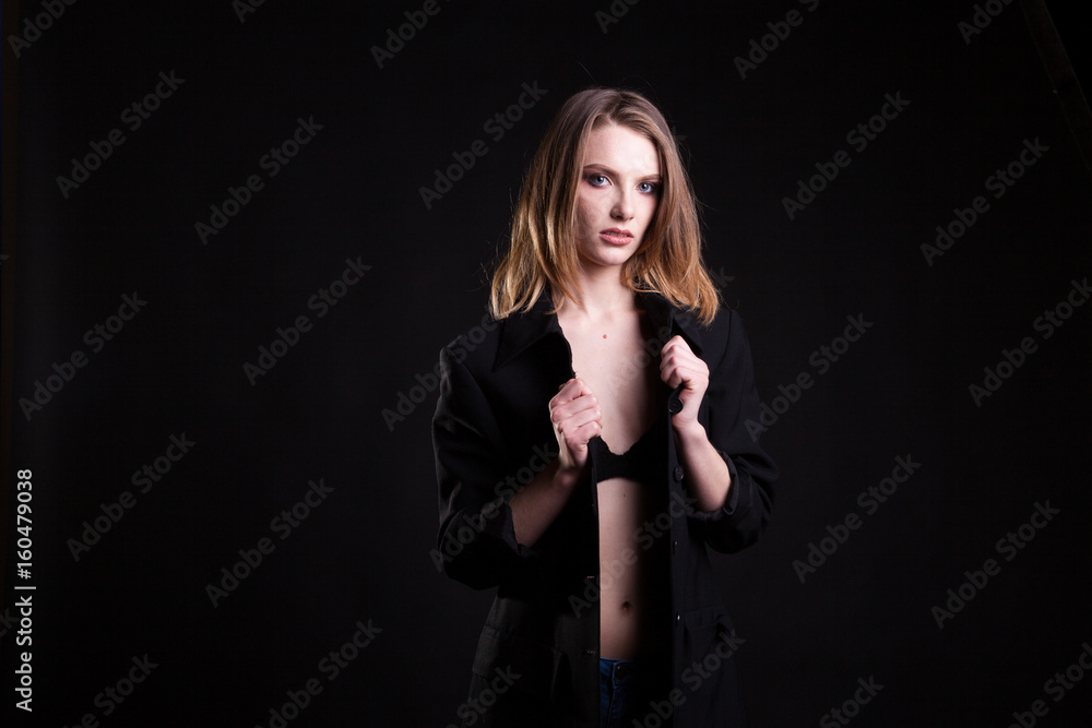 Beautiful blonde in casual fashion clothes in studio photo on black background. Sexyality and sensuality Beautiful blonde in casual fashion clothes in studio photo on black background. Sexyality and sensuality