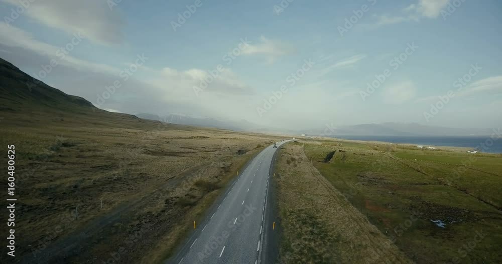 Aerial view of the beautiful landscape in the countryside. Copter flying over the traffic road on the shore of the sea. Aerial view of the beautiful landscape in the countryside. Copter flying over the traffic road on the shore of the sea.