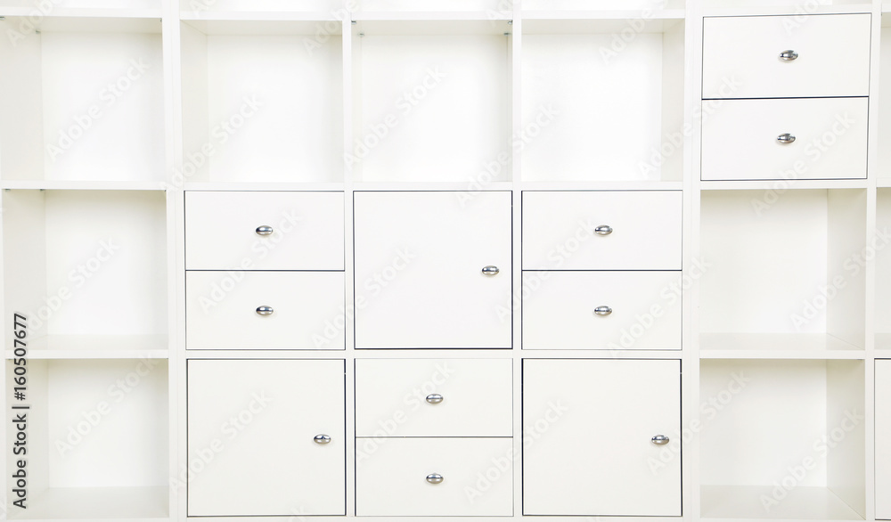 Empty shelves in white wooden rack, close up Empty shelves in white wooden rack, close up