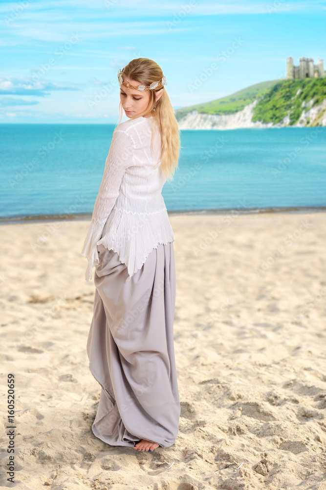 female elf on a beach wearing a crown female elf on a beach wearing a crown