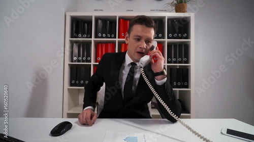 4k POV. Young Handsome businessman in formal suit ask You wait and precise some Your questions by telephone with his boss. Consultation customer service concept