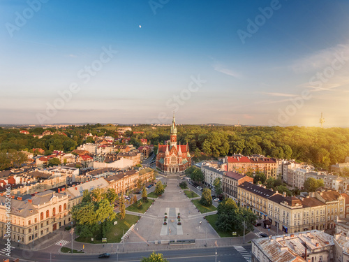 Drone aerial view of Krakow old town, main square and church at sunset time