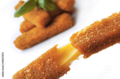 Canvas Print Broken deep fried stick with stretchy cheese on blurred background