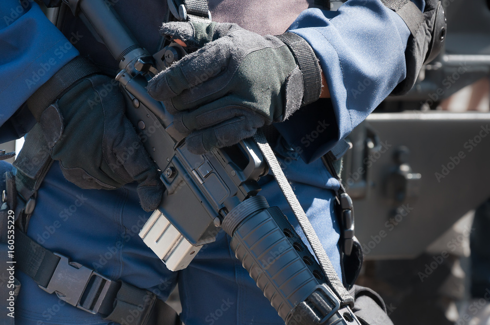 Soldier holding a machine with automatic gun.Preparation for military action.Soldier dressed in protective equipment Soldier holding a machine with automatic gun.Preparation for military action.Soldier dressed in protective equipment