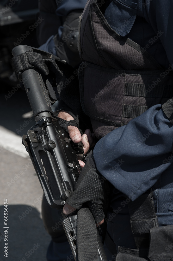 Soldier holding a machine with automatic gun.Preparation for military action.Soldier dressed in protective equipment Soldier holding a machine with automatic gun.Preparation for military action.Soldier dressed in protective equipment