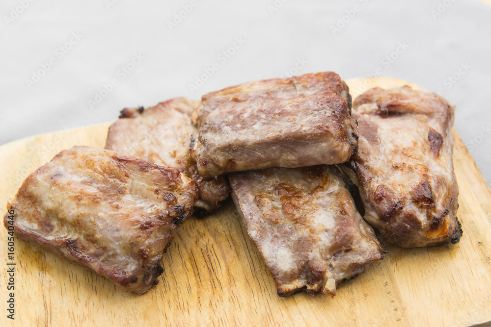 grilled pork rib on wooden cutting board, close up grilled pork rib on wooden cutting board, close up