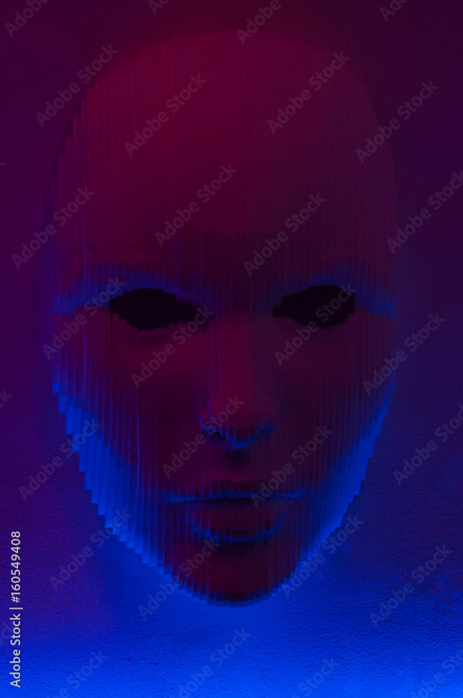 Face on the wall in blue light