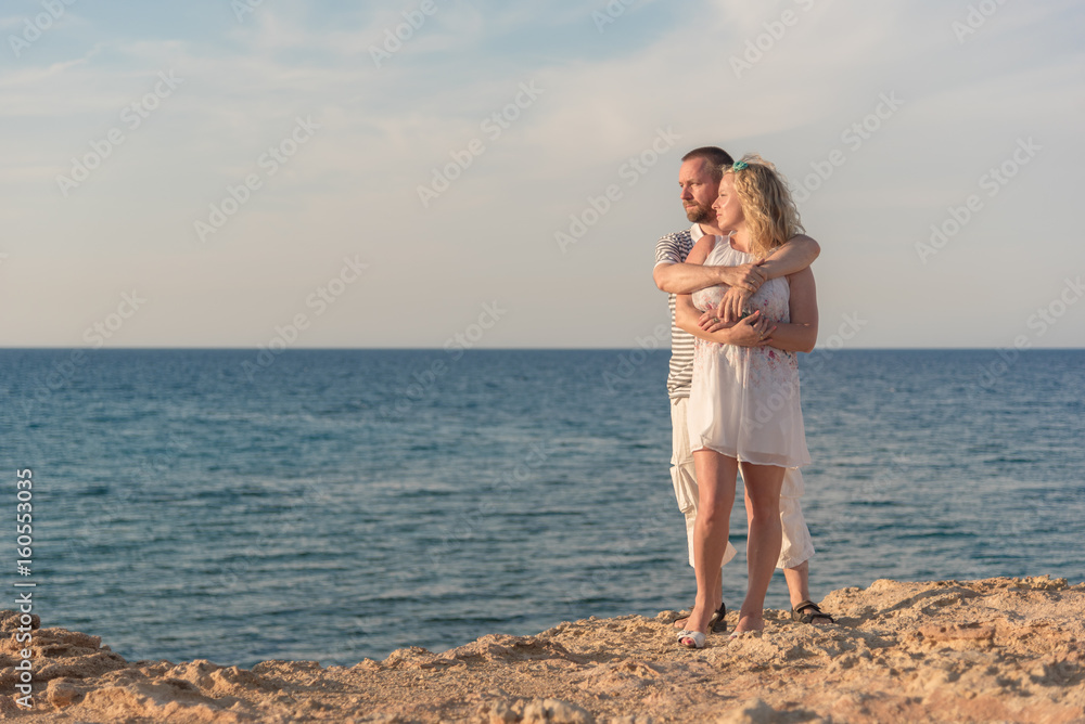 Young couple hugging at the sea