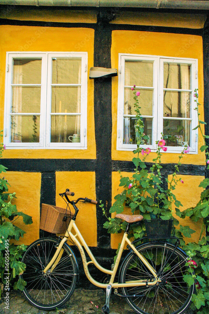 bycicle on a brick yellow wall