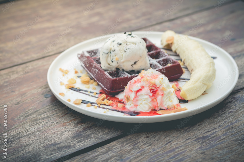 chocolate waffles with vanilla ice cream, banana, whipped cream and strawberry syrup chocolate waffles with vanilla ice cream, banana, whipped cream and strawberry syrup