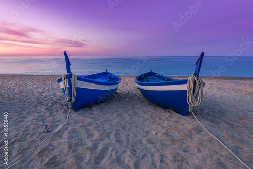 Blue wooden fishing boats on beach