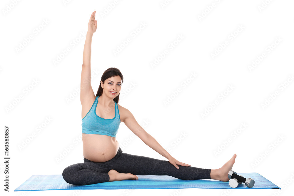 Young beautiful pregnant woman doing yoga exercise isolated on white Young beautiful pregnant woman doing yoga exercise isolated on white