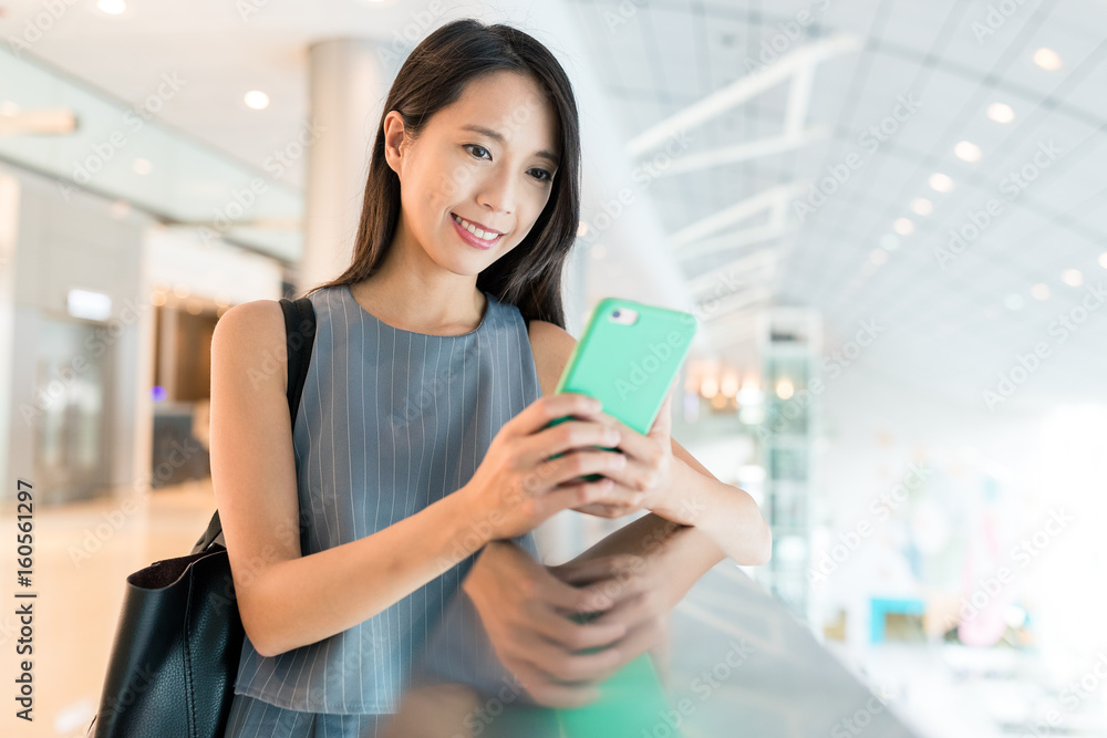 Woman use of mobile phone in shopping mall Woman use of mobile phone in shopping mall