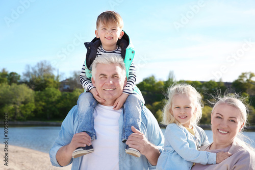 Happy grandparents with lit...